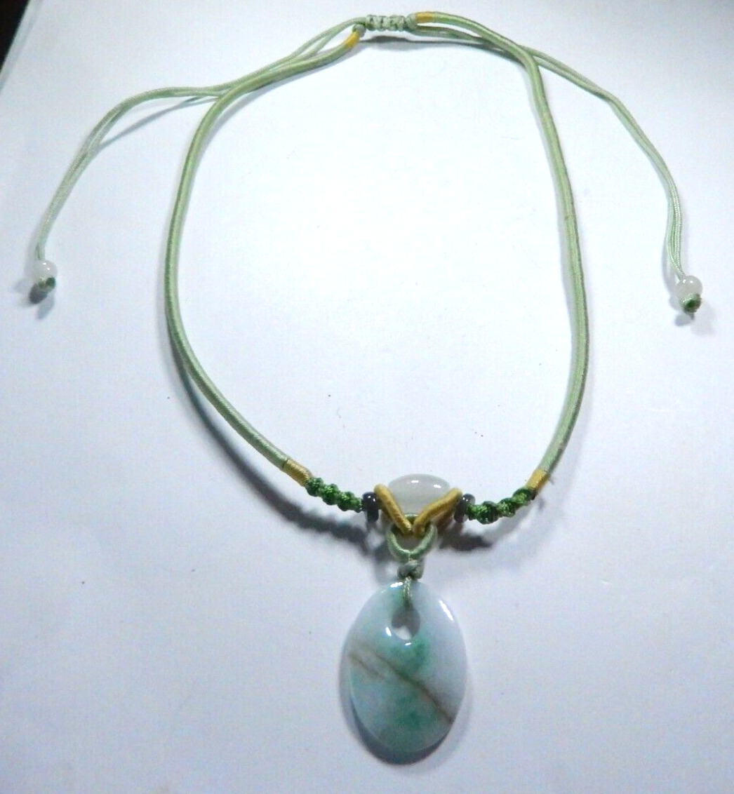 Jade Pendant on corded adjustable necklace. Cord adjustable 15 To 24 inches.