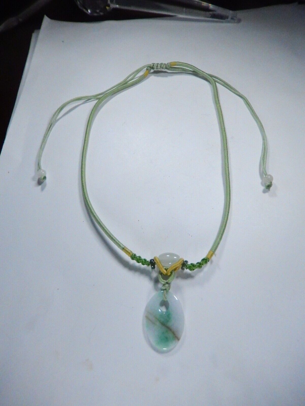 Jade Pendant on corded adjustable necklace. Cord adjustable 15 To 24 inches.