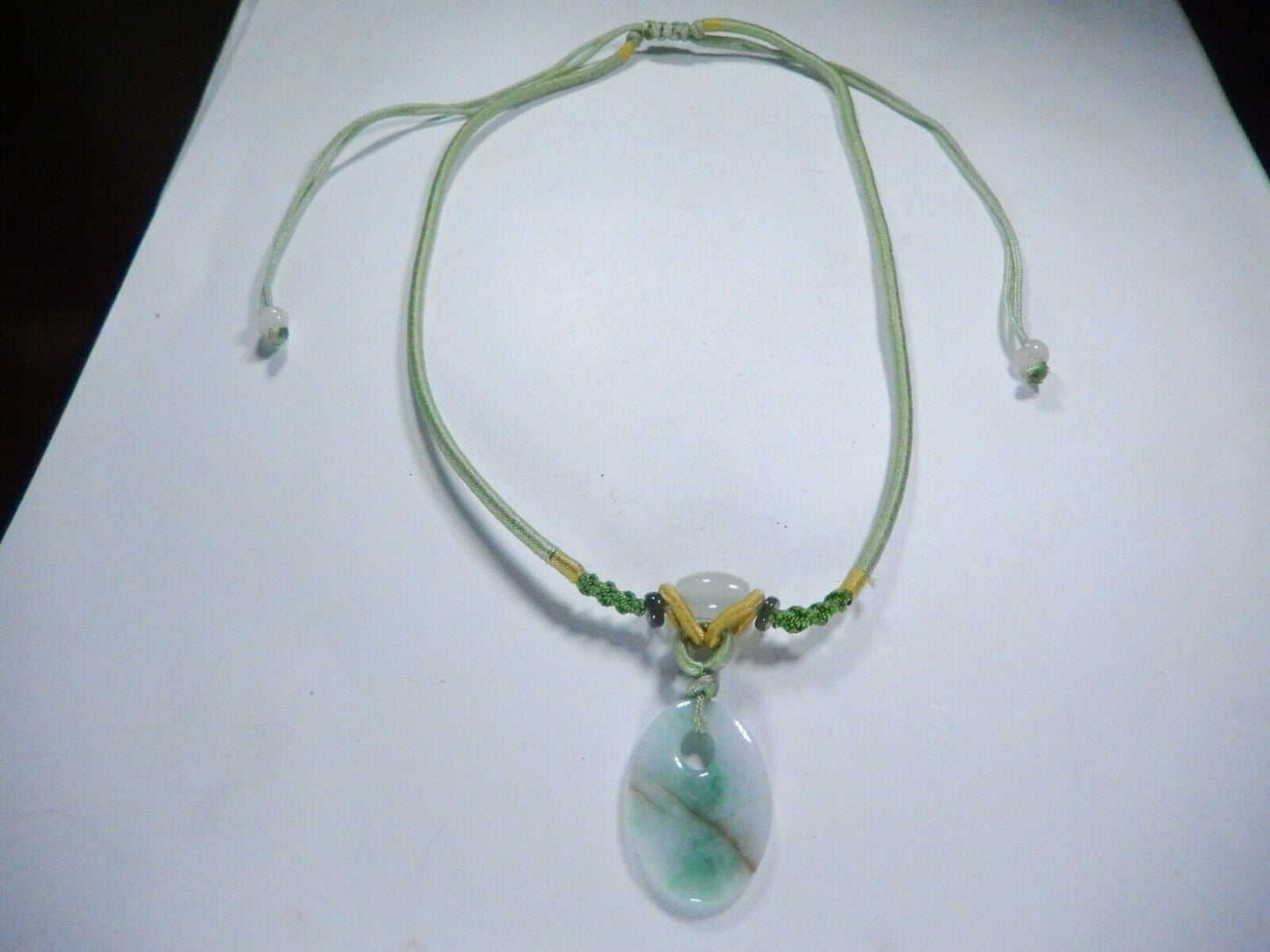 Jade Pendant on corded adjustable necklace. Cord adjustable 15 To 24 inches.